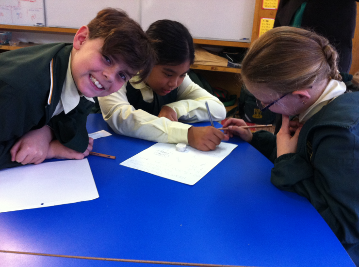 From left to right: Year 4 students Ryan, Isabella and Kaylen working collaboratively to solve mathematical problems.