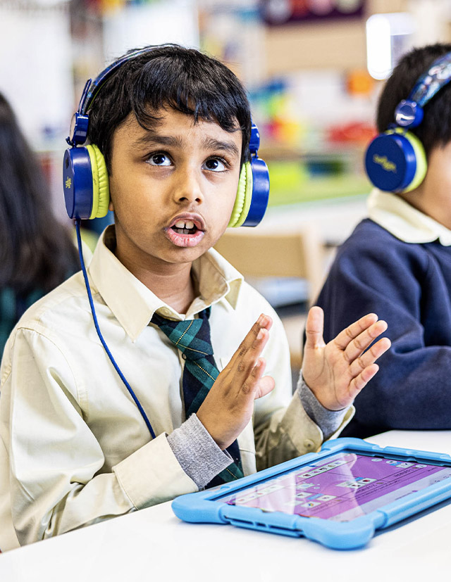 Student with headphones in at St Francis of Assisi Catholic Primary School Glendenning