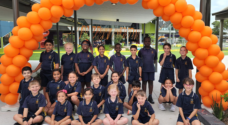 Students under balloon banner for harmony day at St Francis of Assisi Catholic Primary School Glendenning