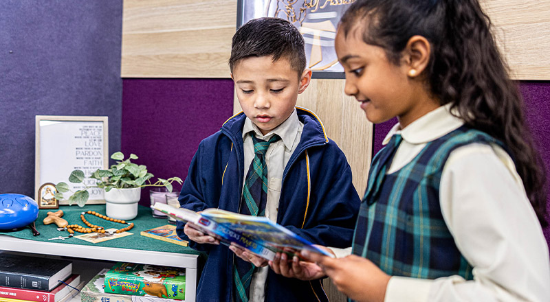 Children holding bible at St Francis of Assisi Catholic Primary School Glendenning
