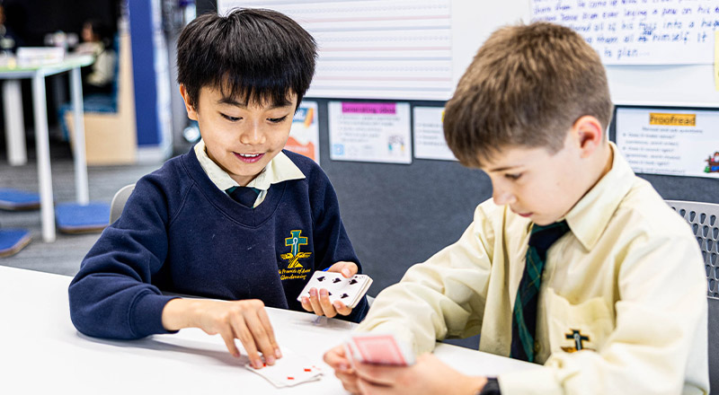 students playing cards at St Francis of Assisi Catholic Primary School Glendenning