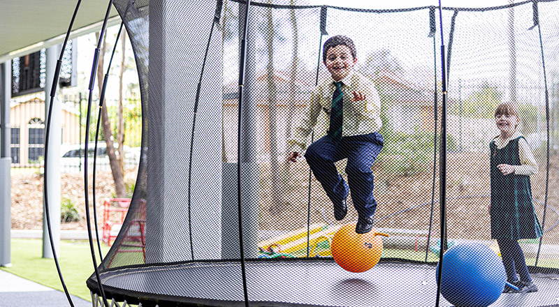 Children on trampoline at St Francis of Assisi Catholic Primary School Glendenning