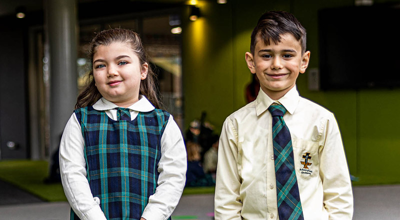 Two students stand in St Francis of Assisi Catholic Primary School Glendenning