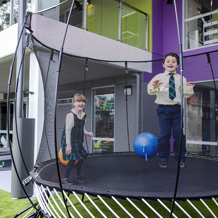 Children on trampoline at St Francis of Assisi Catholic Primary School Glendenning