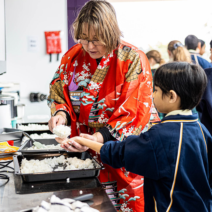 Student and teacher making sushi at St Francis of Assisi Catholic Primary School Glendenning