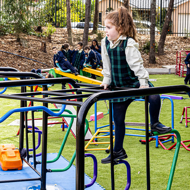 Child on play equipment at St Francis of Assisi Catholic Primary School Glendenning