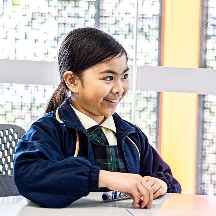 Girl grinning from St Francis of Assisi Catholic Primary School Glendenning