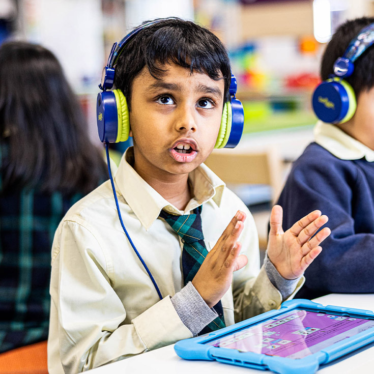 Student with headphones in at St Francis of Assisi Catholic Primary School Glendenning