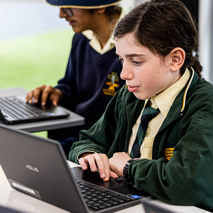 Student on laptop at St Francis of Assisi Catholic Primary School Glendenning