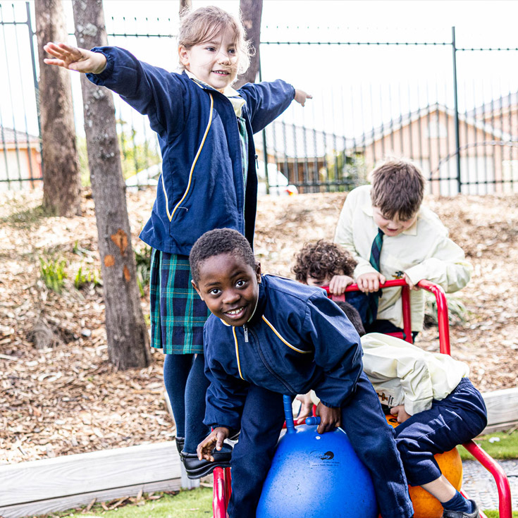 Students on play equipment at St Francis of Assisi Catholic Primary School Glendenning