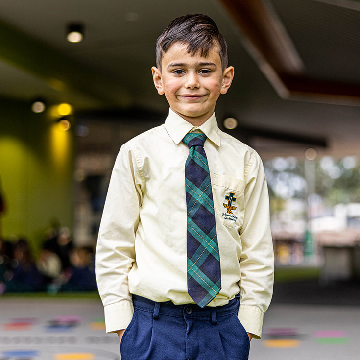 Boy in uniform at St Francis of Assisi Catholic Primary School Glendenning