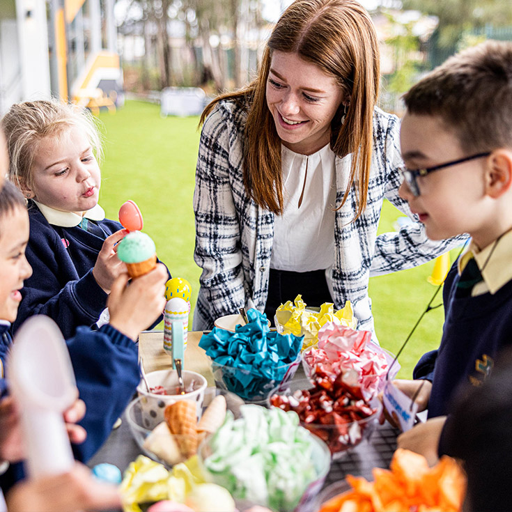 Teacher and students smiling at St Francis of Assisi Catholic Primary School Glendenning